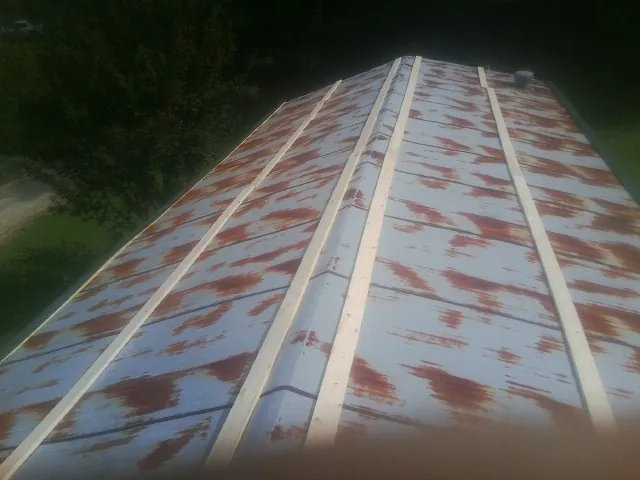 Rusted metal roof panels with new wood purlins before replacement — Storm Damage Roof Repair in Mayetta by Roofing Brothers
