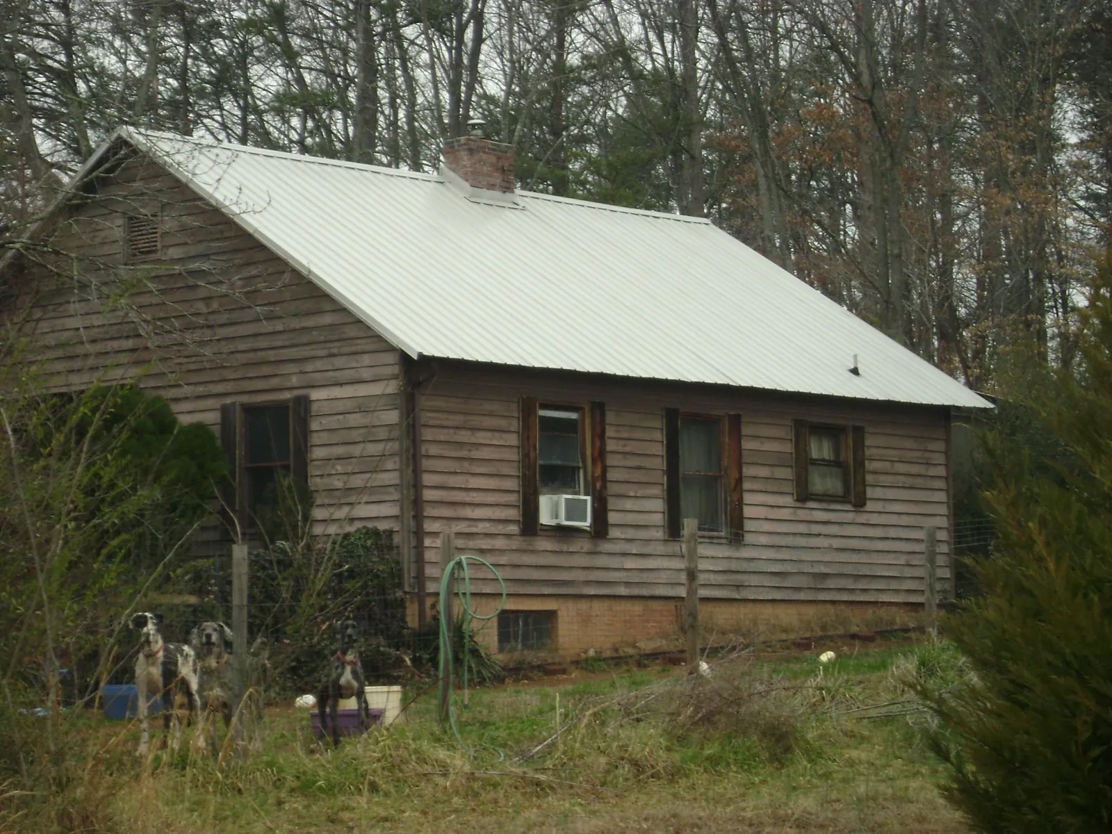 White metal roof on an old wood sided farmhouse, from a Metal Roof Installation job in Mayetta